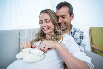 Pregnant couple sitting on sofa