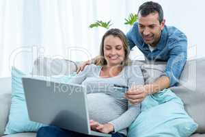 Couple shopping online with a credit card