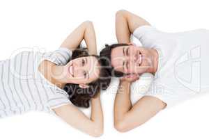 Happy couple lying on the floor head to head