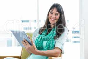 Pregnant woman using digital tablet