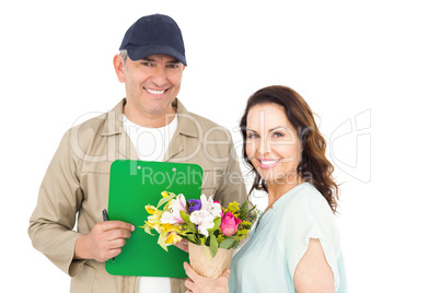 Female customer signing on paper with delivery man