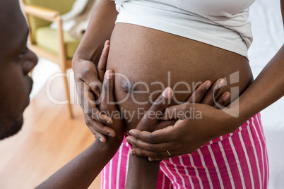 Man touching pregnant woman belly