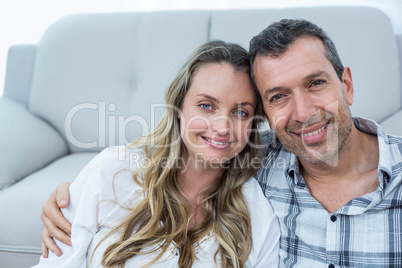 Pregnant couple sitting floor