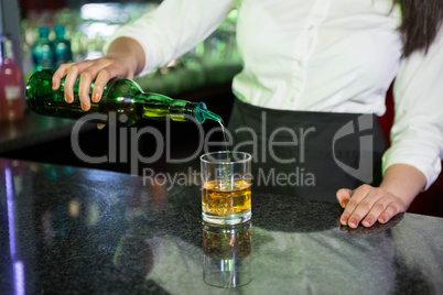 Bartender pouring whiskey in a glass