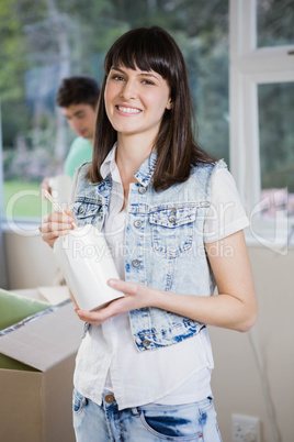 Young woman eating noodles at home