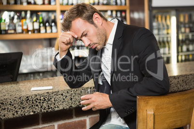 Tired man having a whiskey