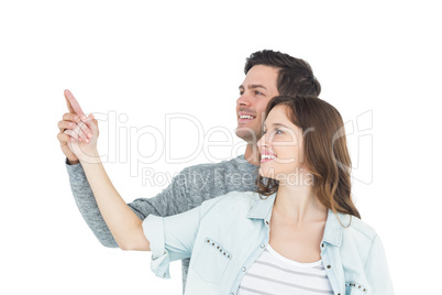 Couple embracing and pointing up