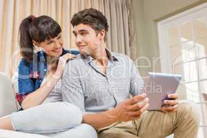 Young couple using a digital tablet