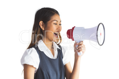 Businesswoman shooting through a megaphone