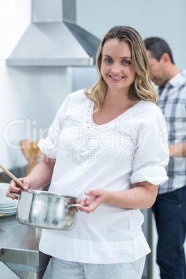 Pregnant woman busy in kitchen