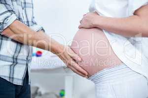 Man touching pregnant womans belly