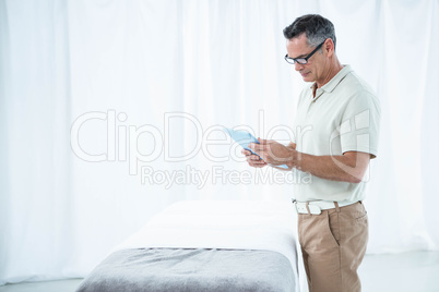 Physiotherapist using digital tablet