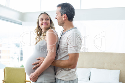 Man holding pregnant womans stomach