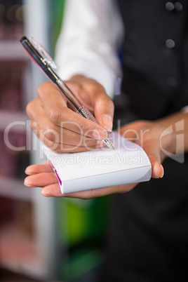 Waiter writing down an order