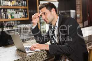 Handsome man using laptop computer