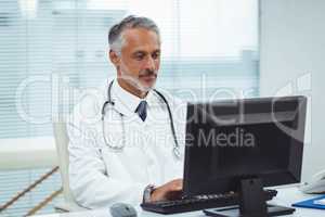Doctor typing on his computer