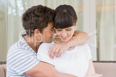 Romantic couple embracing on sofa