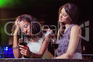 Woman having drinks and comforting her depressed friend