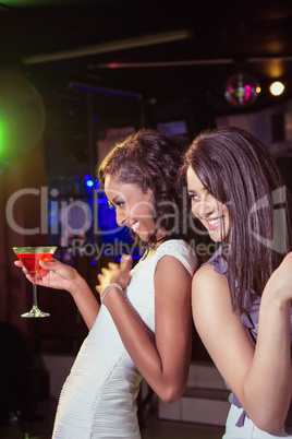 Happy young women having red cocktail