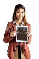 Smiling businesswoman pointing a tablet