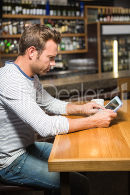 Handsome man using tablet computer