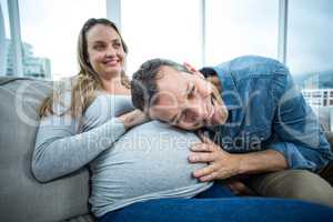 Man listening to pregnant womans stomach