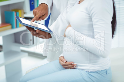 Pregnant woman interacting with doctor