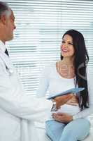 Pregnant woman interacting with doctor