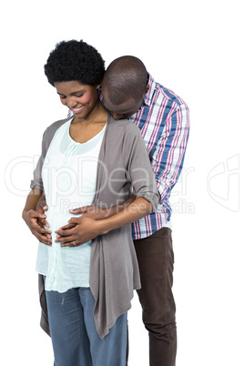 Pregnant couple smiling and embracing