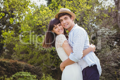 Young couple cuddling outdoors