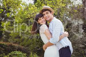 Young couple cuddling outdoors