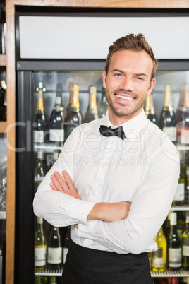 Handsome barman with arms folded