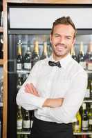 Handsome barman with arms folded