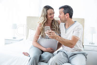 Couple looking at smartphone