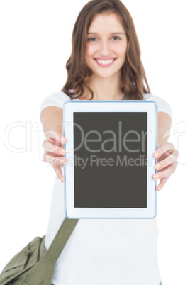 Portrait of happy female student showing tablet