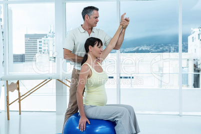 Physiotherapist giving physiotherapy to pregnant woman