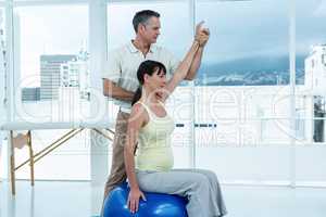 Physiotherapist giving physiotherapy to pregnant woman