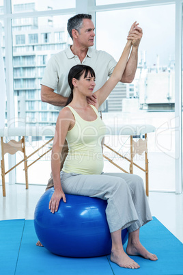 Physiotherapist giving physiotherapy to pregnant woman