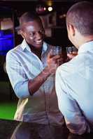 Two men toasting with glass of whiskey