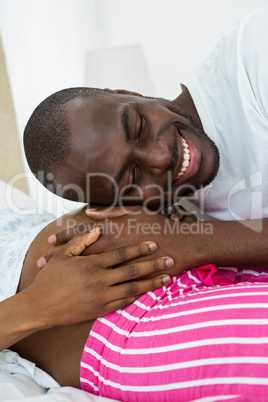 Man listening to pregnant womans stomach