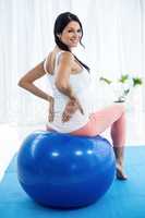 Pregnant woman exercising on exercise ball