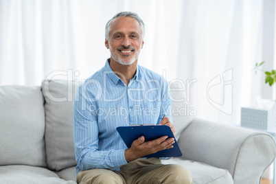 Doctor sitting with a clipboard