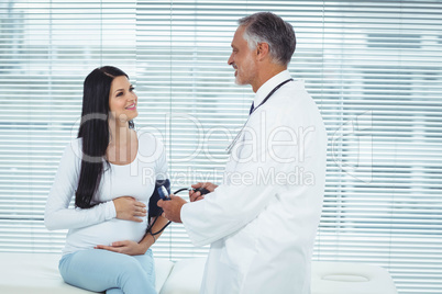 Doctor measuring pressure of pregnant woman