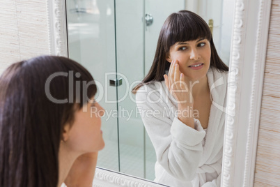 Beautiful young woman in white bathrobe