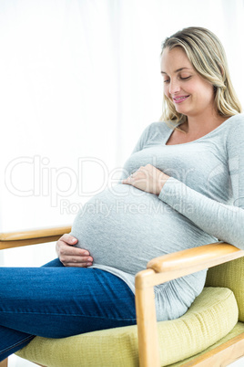 Pregnant woman holding her stomach