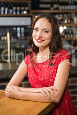 Pretty woman leaning on a wooden table