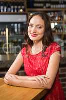 Pretty woman leaning on a wooden table