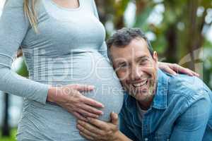 Man listening to pregnant womans stomach