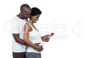 Pregnant couple holding color swatches