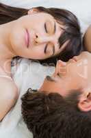 young couple relaxing on bed